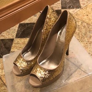 Rachel Roy gold glitter platform heels.